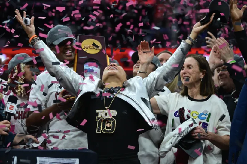 South+Carolina+Head+Coach+Dawn+Staley+celebrating+the+national+championship+under+confetti+with+her+team.+